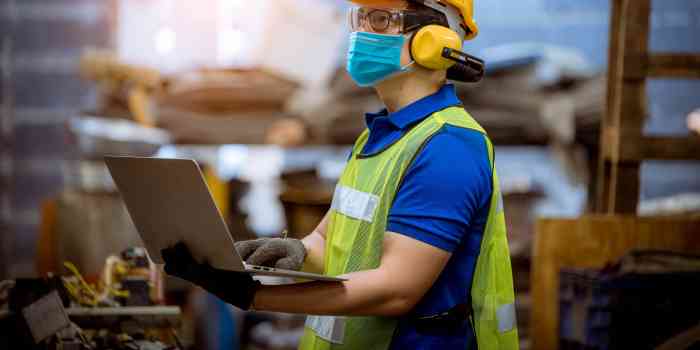 Man wearing PPE inspecting warehouse safety