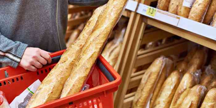 a retail shopper holding a baguette