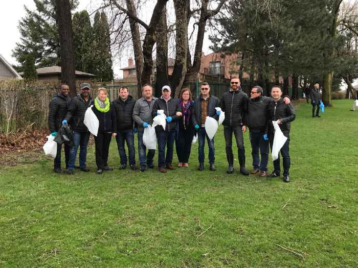 Fiera Foods staff holding garbage bags after Strathburn Park cleanup
